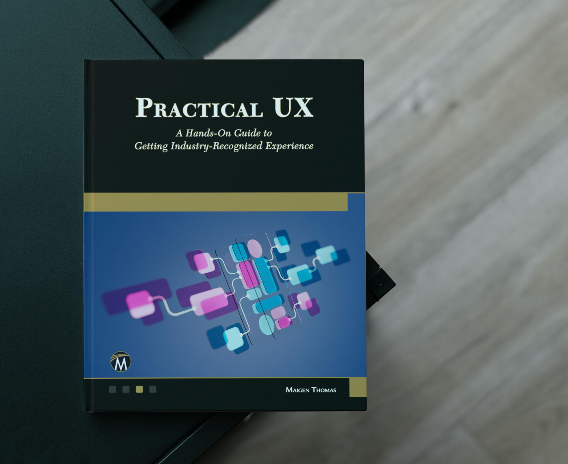 The Practical UX book laying on a table